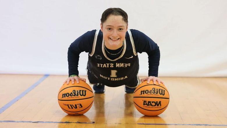 Athlete balancing on two basketballs